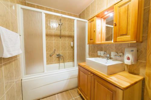 a bathroom with a sink and a shower at Hotel & Resort Gacka in Mojkovac