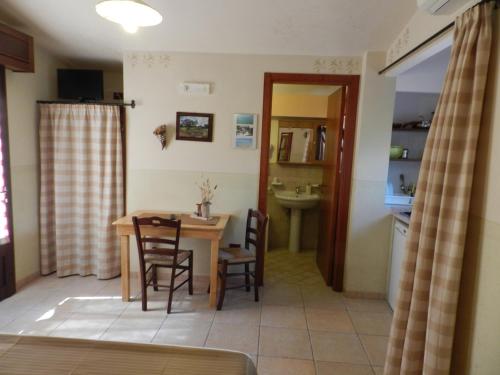 a kitchen and dining room with a table and chairs at Macchia Salentina in Baia Di Gallipoli