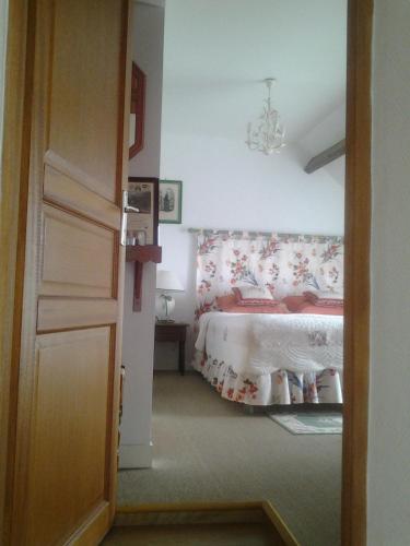サン・メロワール・デ・ゾンドにあるLa Pastourelle Chambre d Hôtesのベッドルーム1室(ベッド1台、赤と白の毛布付)