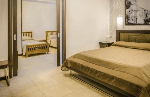 a bedroom with a bed and a mirror at Hotel Grazia Eboli in Eboli