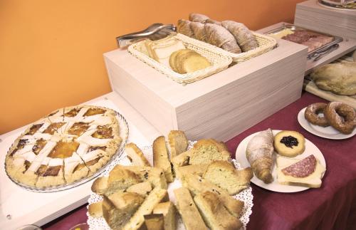 a table with various types of bread and pastries at Hotel Grazia Eboli in Eboli
