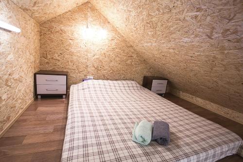 a small room with a bed in a attic at Valaste Puhkeküla in Kohtla-Järve