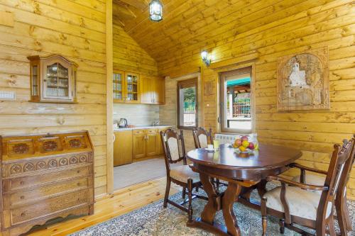 a dining room with a table and chairs in a cabin at Hotel & Resort Gacka in Mojkovac