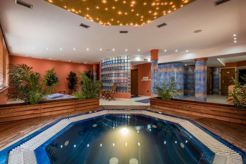 a pool in the lobby of a hotel at Penzion Fontana in Bešeňová
