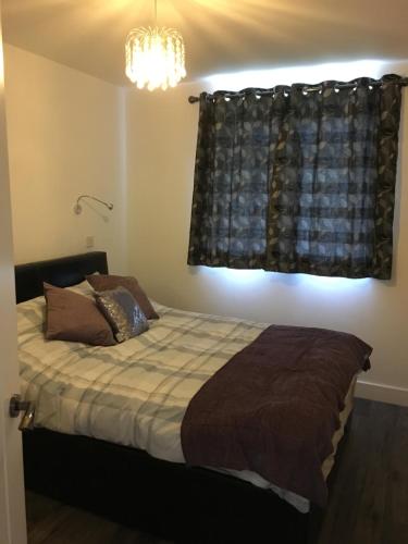 a bedroom with a bed and a window at The Annex, Fruit and Honey Farm in Bridgwater