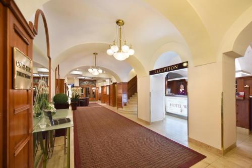 a hallway in a building with a pharmacy at Austria Classic Hotel Wien in Vienna
