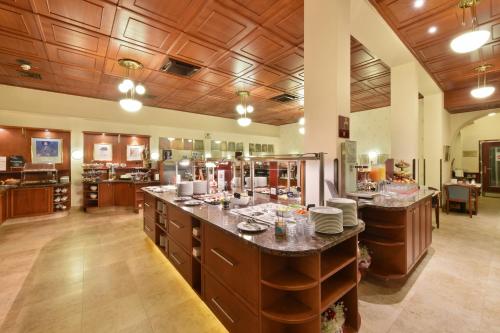 a large kitchen with a large island in the middle at Austria Classic Hotel Wien in Vienna