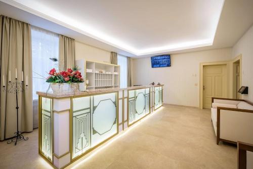 a large room with a counter with flowers on it at Royal Palace in Turčianske Teplice
