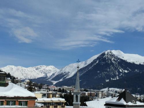 a view of a town with snow covered mountains at Holiday accommodation - swimming pool available in Davos
