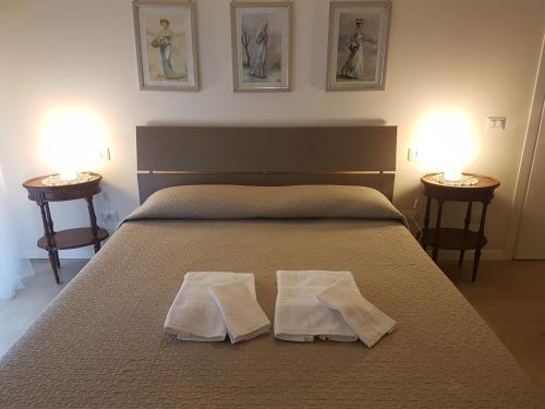 a bedroom with a bed with two towels on it at Ai Due Vecchi Ulivi in Garlate