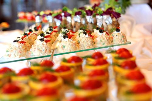 a bunch of appetizers on display on a buffet at Hotel Relaks Wellness & SPA in Karpacz