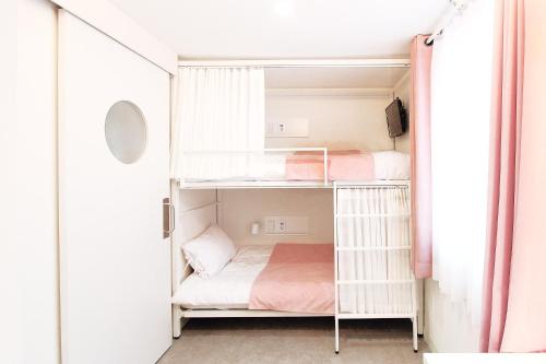 a small room with two bunk beds in it at Orbit - For foreigners only in Seoul