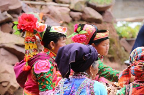 a group of women in traditional clothing standing together at Erhaike Seaview Inn in Dali