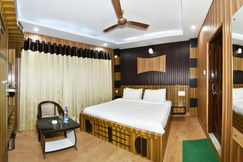 a bedroom with a bed and a desk in a room at Surbhi Guest House in Dharamshala
