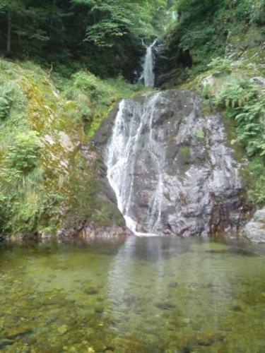 a waterfall in the middle of a body of water at Hotel Residence Giardini in Piode