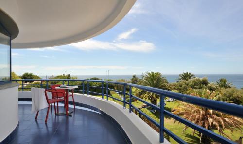 a balcony with a table and chairs and the ocean at Hotel Pestana Cascais Ocean & Conference Aparthotel in Cascais