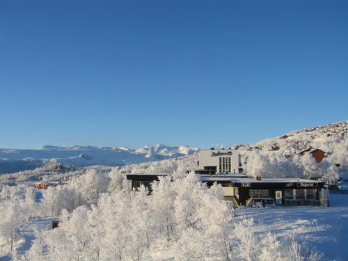 a building on top of a snow covered mountain at Radisson Blu Resort, Beitostølen in Beitostøl