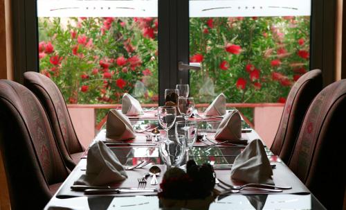 a table with glasses and napkins on top at Pestana Sintra Golf Resort & SPA Hotel in Sintra