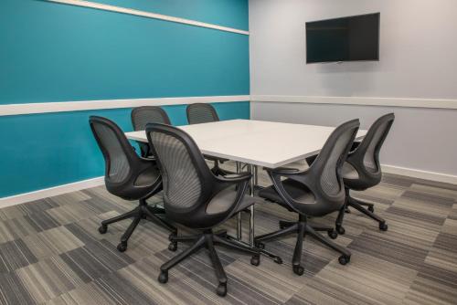 a conference room with a table and chairs at De Vere Latimer Estate in Chesham