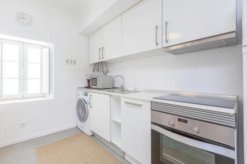 a white kitchen with a sink and a dishwasher at Pátio da Rainha A by NOOK in Monte Estoril
