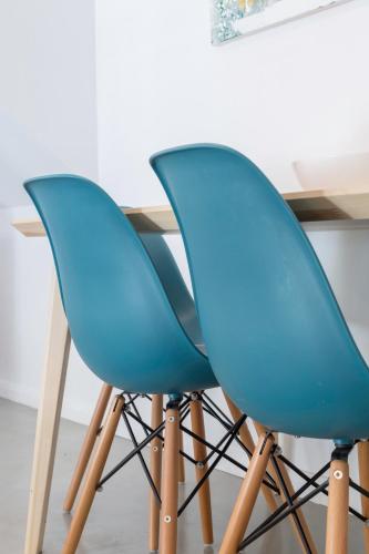two blue chairs sitting next to a table at Pátio da Rainha A by NOOK in Monte Estoril