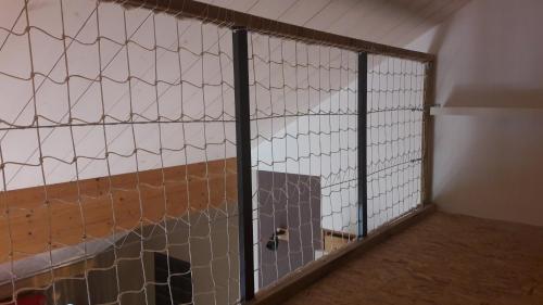 a cage with a tennis court inside of it at Les Gites du Belvedere - Arbois in Arbois