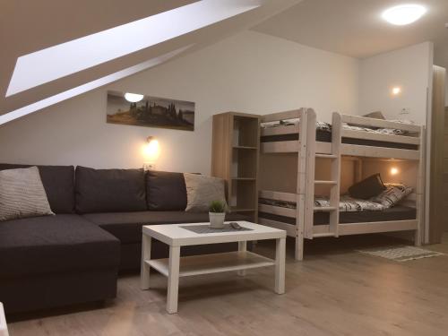 a living room with a couch and bunk beds at Sobe-Rooms Kvatric in Zagreb
