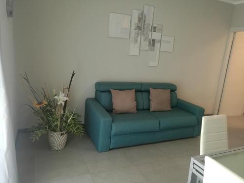 a blue couch with two pillows in a living room at Lingotto Residence in Turin