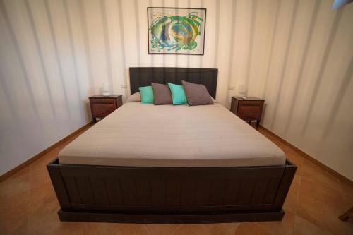 a large bed in a bedroom with two night stands at Beach Front Villa-Families & Pet Friendly in Porto Santo Stefano