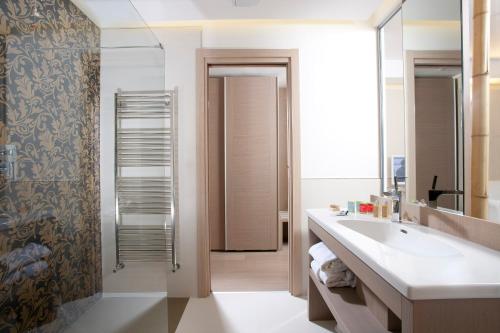 a bathroom with a sink and a shower at Hotel Aurora in Lido di Jesolo