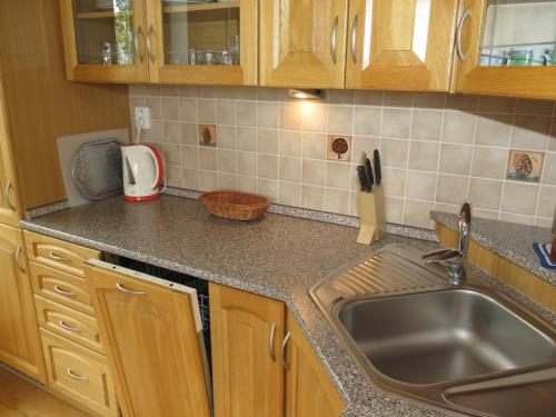 a kitchen with a sink and a counter top at Apartmán Tuček in Štrbské Pleso