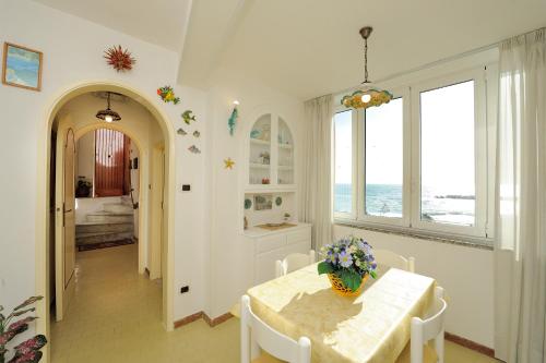 a dining room with a table with flowers on it at That's Atrani in Atrani