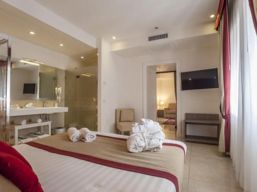 a hotel room with a bed with towels on it at Hotel San Pietro in Naples