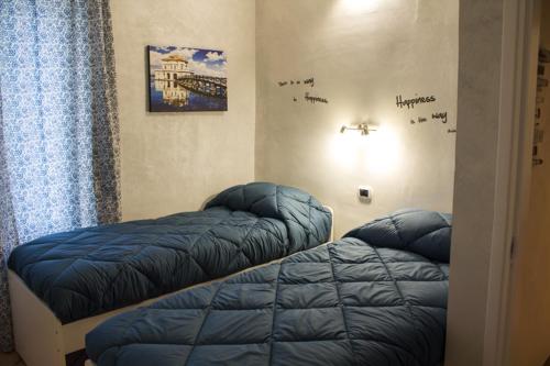 a bedroom with two blue beds in a room at Residenza Maranto in Naples