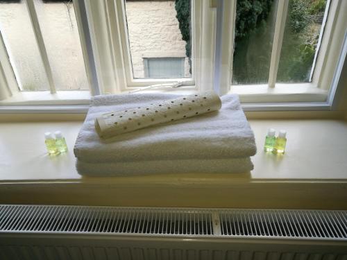 a towel sitting on a window sill next to a window at Longbridge House in Shepton Mallet