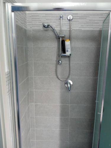a shower in a bathroom with a glass door at Casa Normanna in Monreale
