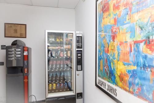 a vending machine filled with bottles of soda at Foresteria Boccadasse in Genova