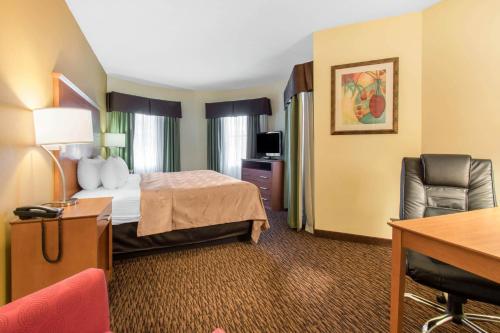 a hotel room with a bed and a desk at Clarion Hotel & Suites University-Shippensburg in Shippensburg