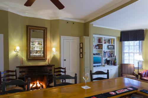 a living room with a fireplace and a table at The Inn at Manchester in Manchester