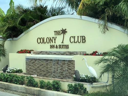 a sign for the colony club inn and suites at Colony Club Inn & Suites in Nassau