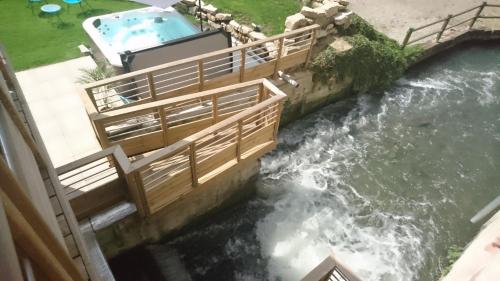 a water dam with a pool and a river at Le Moulin d'Oscar & Spa - Mulhouse Nord in Baldersheim