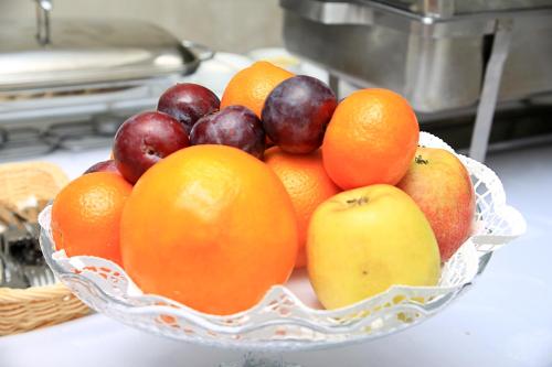 Een fruitschaal met sinaasappels en appels op het aanrecht. bij Restauracja Joanna in Kluczbork