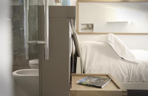 a bedroom with a bed and a book on a table at La Vista di Marina by The First in Riomaggiore