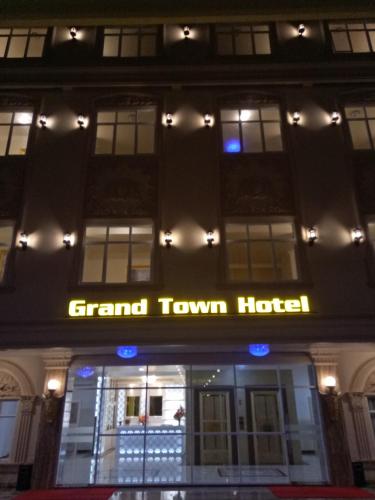 a front of a grand town hotel at night at Grand Town Hotel Mandai in Makassar