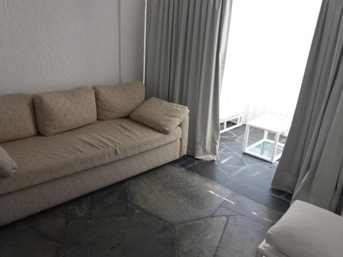 a living room with a couch in front of a window at Vendaval 301 in Punta del Este
