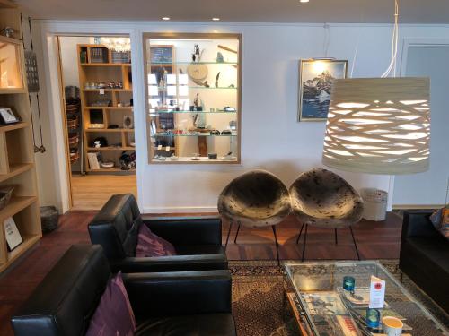 a living room with a couch and a table at Hotel Angmagssalik in Tasiilaq