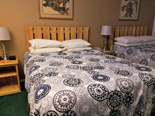 a bedroom with two beds with pillows on them at Soldotna Inn in Soldotna