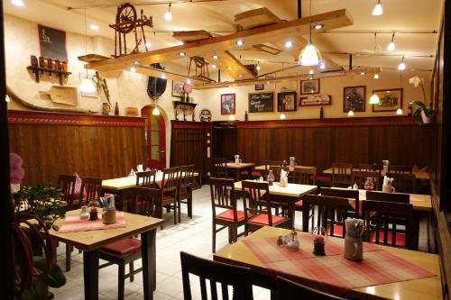 a dining room with tables and chairs in a restaurant at Altstadt-Hotel Zum Hechten in Füssen