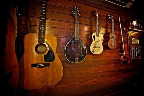 a group of acoustic guitars hanging on a wall at Ferry Inn in Stromness