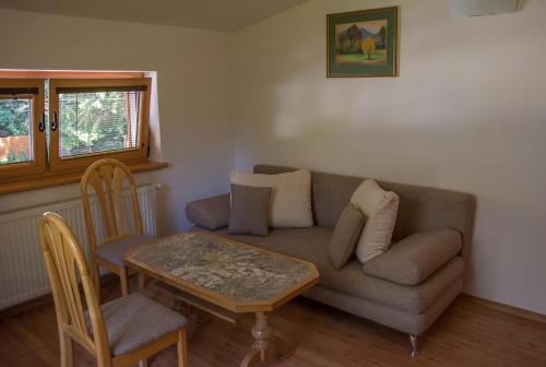 a living room with a couch and a table at Penzión Jozef a apartmány in Demanovska Dolina
